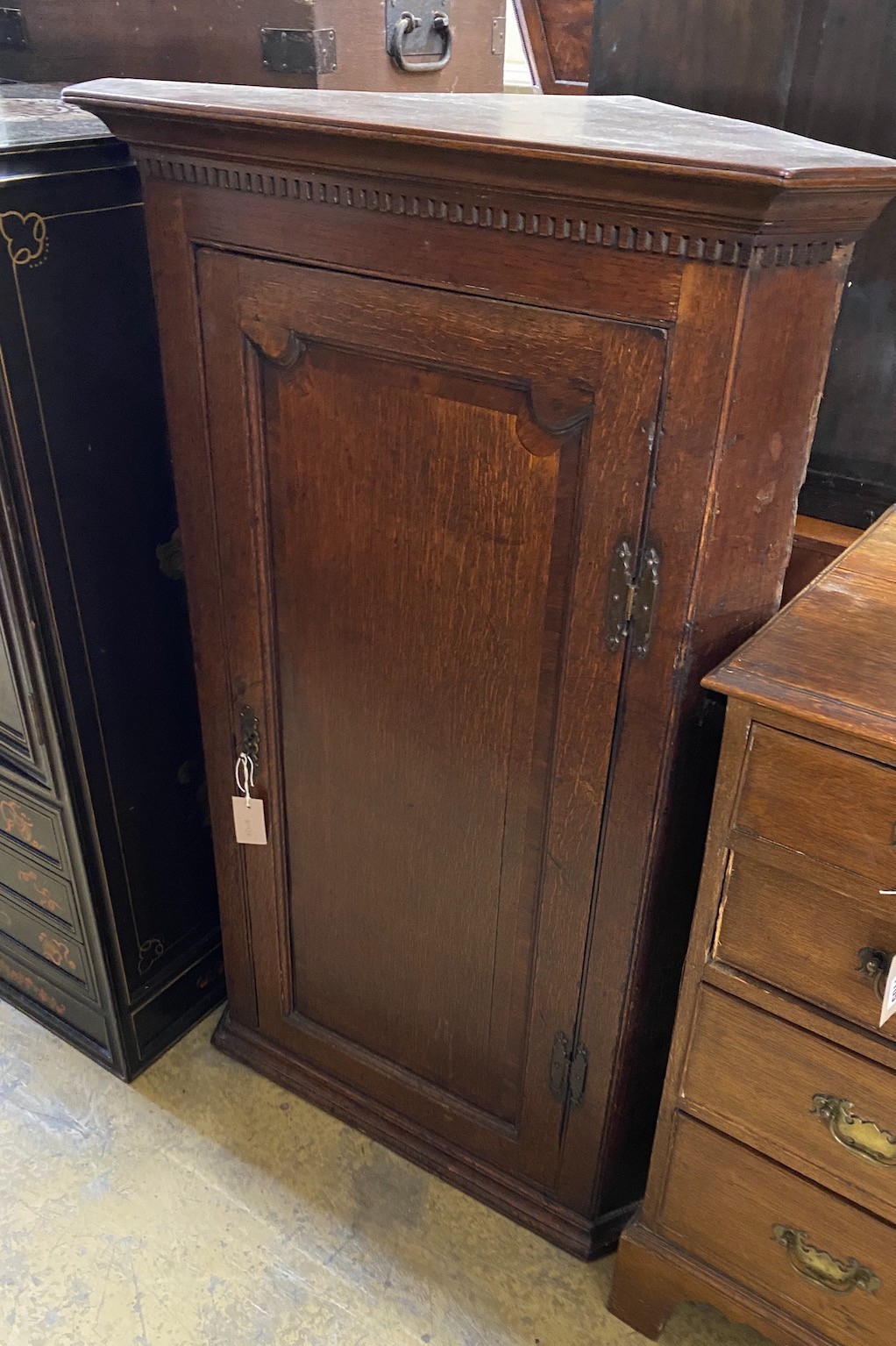 A George III oak hanging corner cabinet, width 72cm, depth 45cm, height 116cm